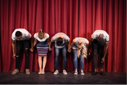 Actors bowing on stage